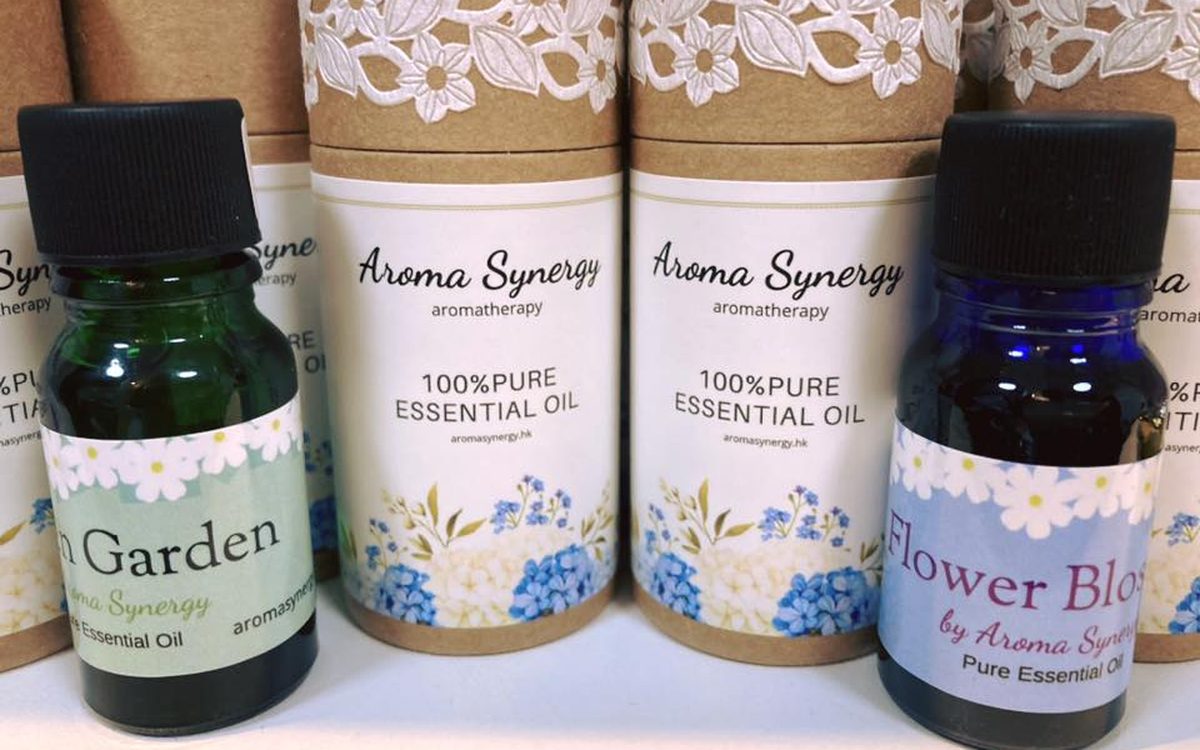 Green Garden and Flower Blossom pure essential oil bottles beside kraft tube packaging
